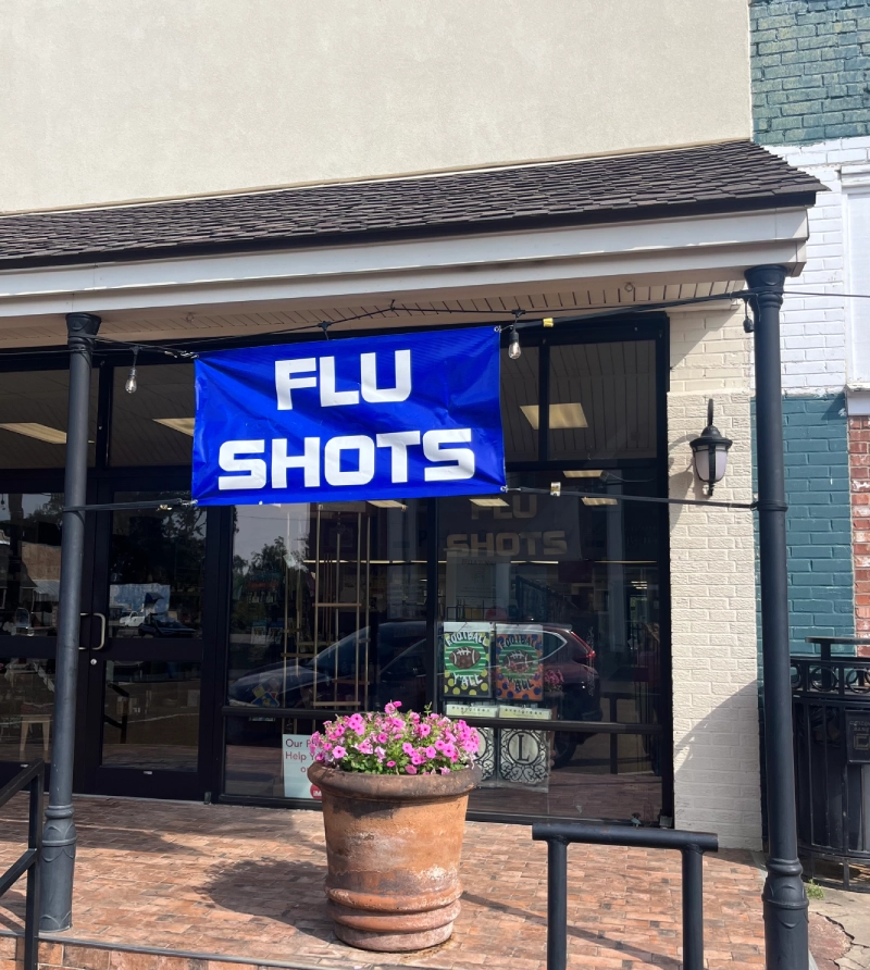 A storefront with a blue 'FLU SHOTS' sign.
