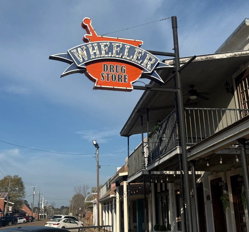 Vintage sign for Wheeler's Saloon on a building corner.